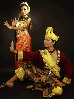 Two dancers in traditional dress performing a cultural dance