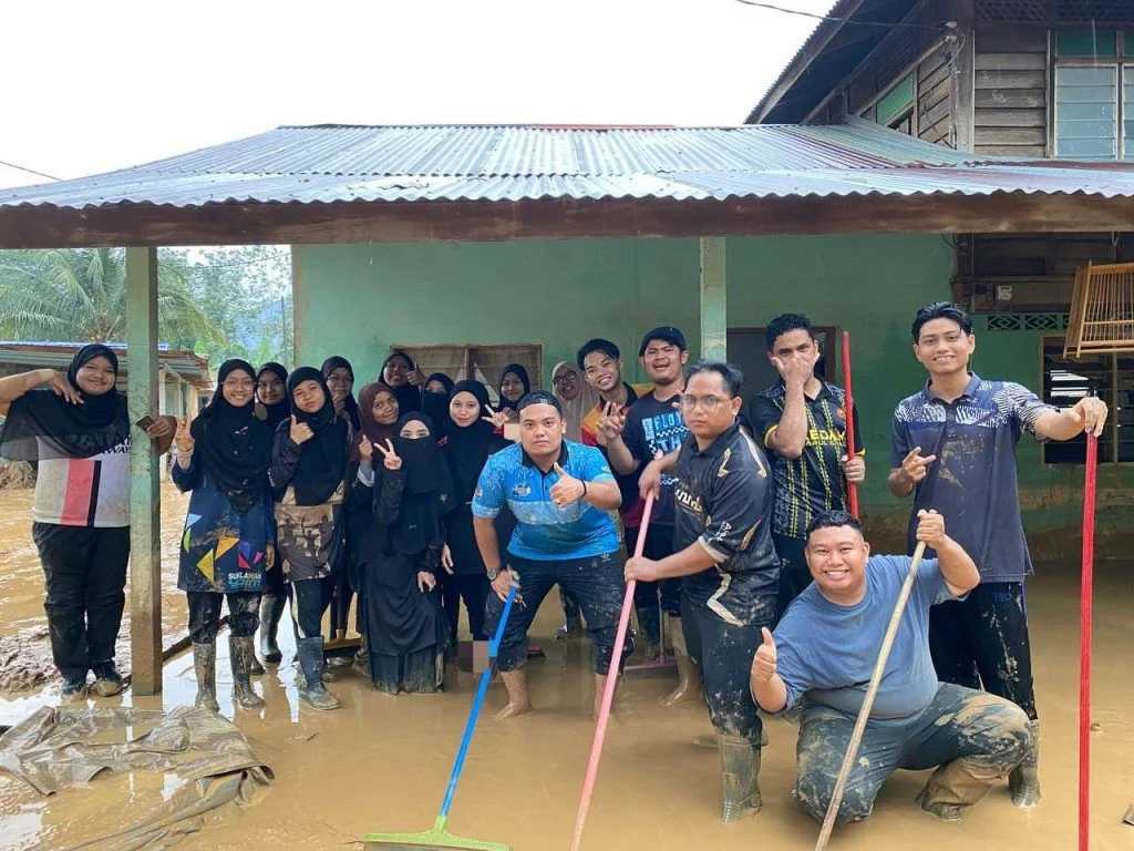 Volunteers standing together at a flood-affected home