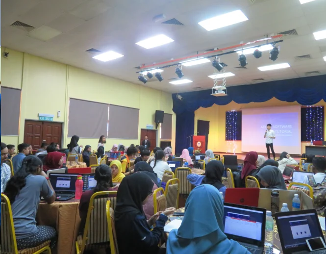 Students learning digital design in a classroom workshop